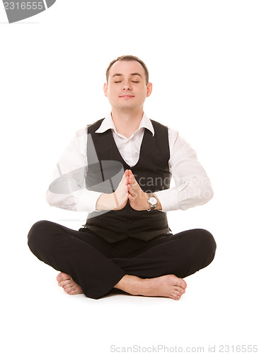 Image of businessman sitting in lotus pose