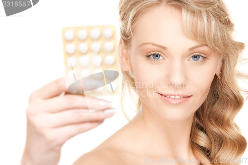 Image of young woman with pills