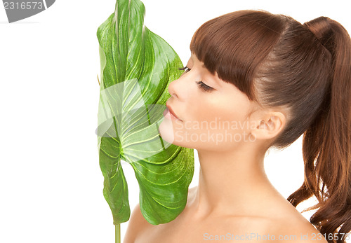 Image of woman with green leaf