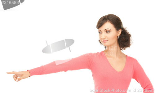 Image of attractive businesswoman pointing her finger