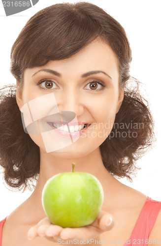 Image of young beautiful woman with green apple