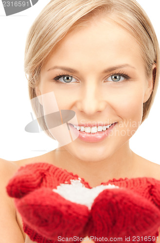 Image of beautiful woman in red mittens with snow