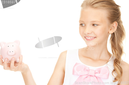 Image of lovely teenage girl with piggy bank