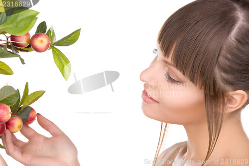 Image of lovely woman with apple twig