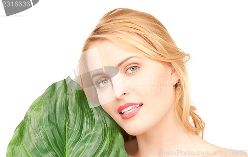 Image of woman with green leaf over white