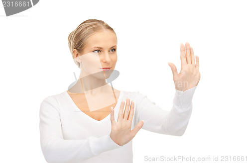 Image of businesswoman working with something imaginary 