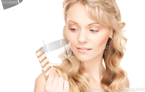 Image of young woman with pills