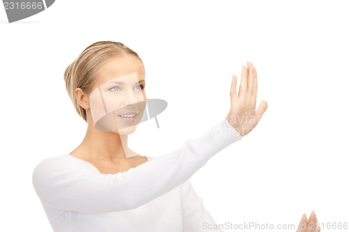 Image of businesswoman working with something imaginary 
