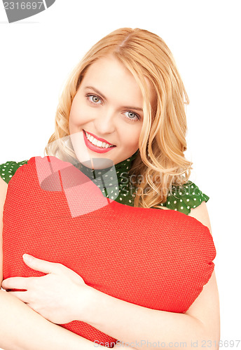 Image of woman with red heart-shaped pillow