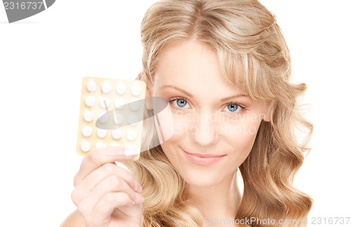 Image of young woman with pills