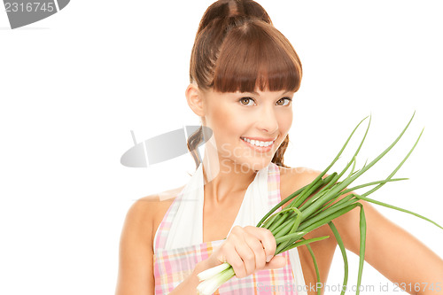 Image of beautiful housewife with spring onions over white