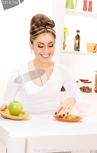 Image of woman with green apple and sandwich