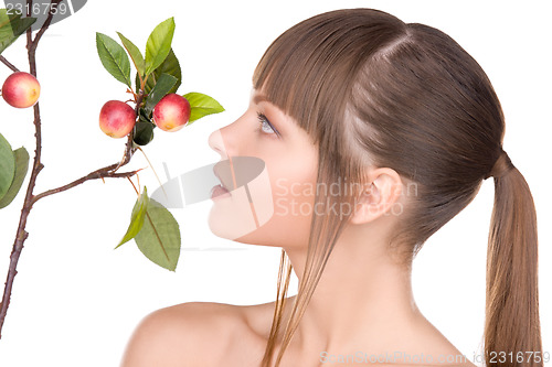 Image of lovely woman with apple twig