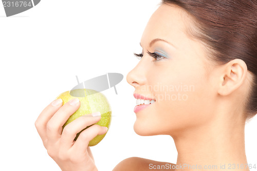 Image of young beautiful woman with green apple