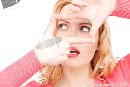 Image of lovely woman creating a frame with fingers              