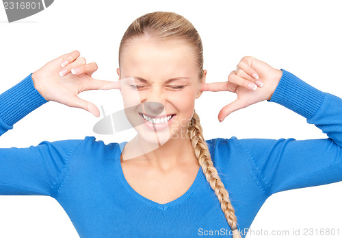 Image of smiling woman with fingers in ears