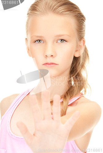 Image of lovely girl showing stop sign