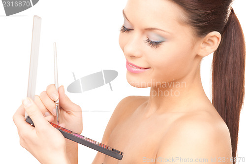 Image of lovely woman with palette and brush