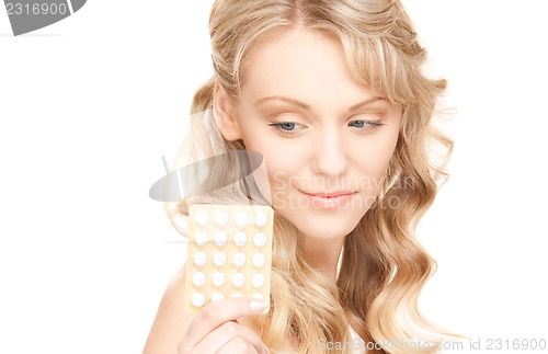 Image of young woman with pills