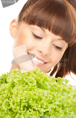 Image of beautiful housewife with lettuce over white