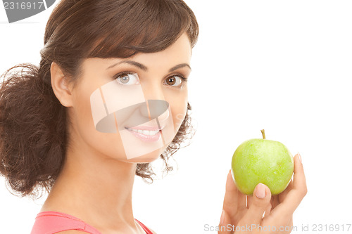 Image of young beautiful woman with green apple