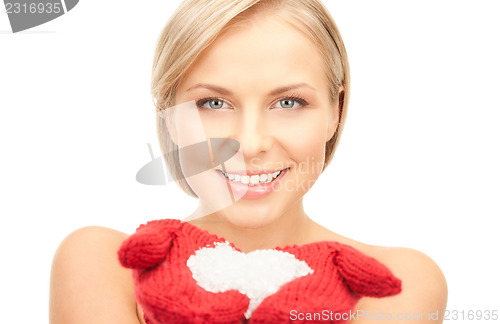 Image of beautiful woman in red mittens with snow