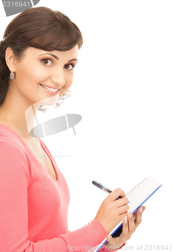 Image of young attractive businesswoman with notebook