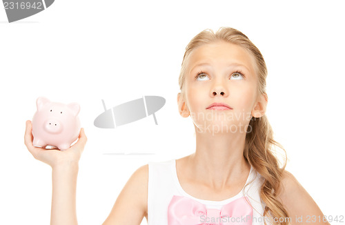 Image of lovely teenage girl with piggy bank