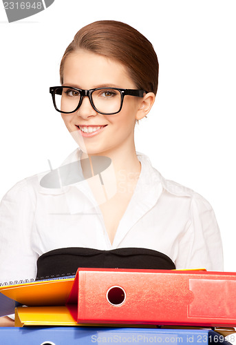 Image of young attractive businesswoman with folders
