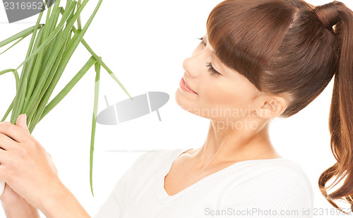 Image of beautiful housewife with spring onions over white