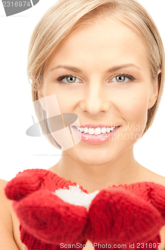 Image of beautiful woman in red mittens with snow