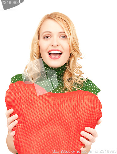 Image of woman with red heart-shaped pillow