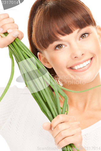 Image of beautiful housewife with spring onions over white