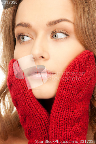 Image of beautiful woman in red mittens 