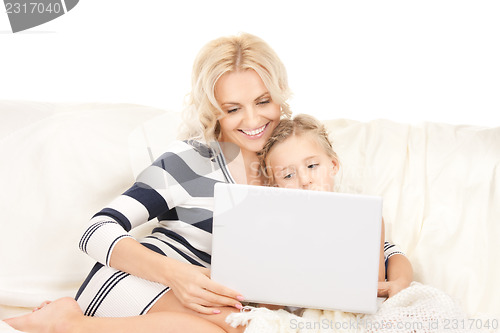 Image of happy mother and child with laptop computer