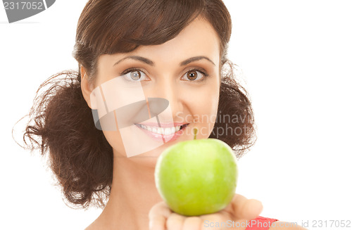Image of young beautiful woman with green apple