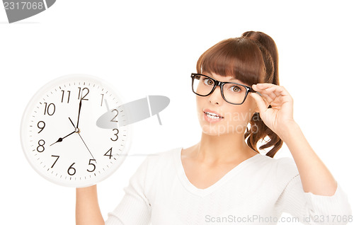 Image of woman holding big clock