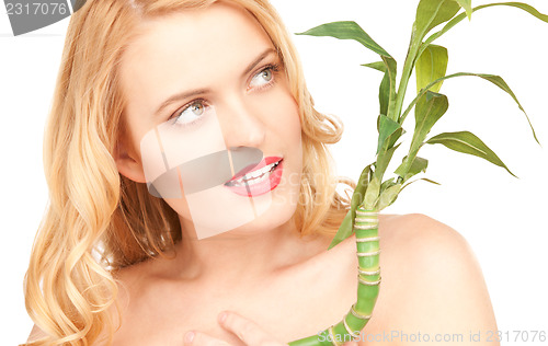 Image of woman with sprout over white