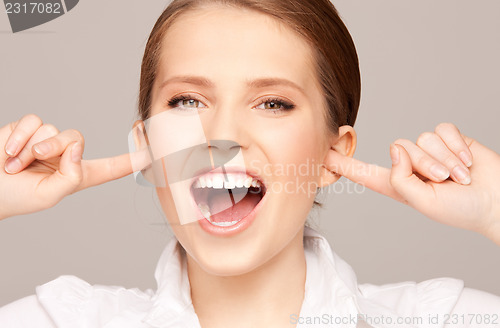 Image of woman with fingers in ears