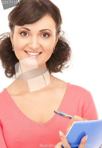 Image of young attractive businesswoman with notebook