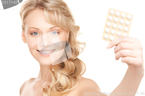 Image of young woman with pills