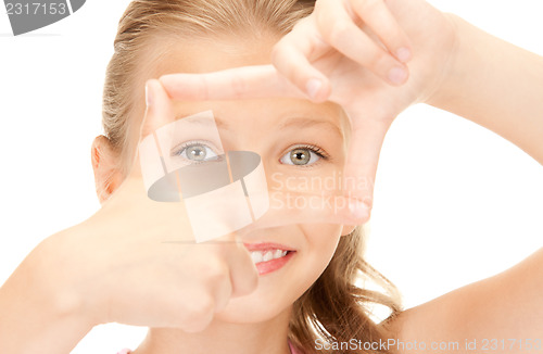 Image of pretty girl creating a frame with fingers