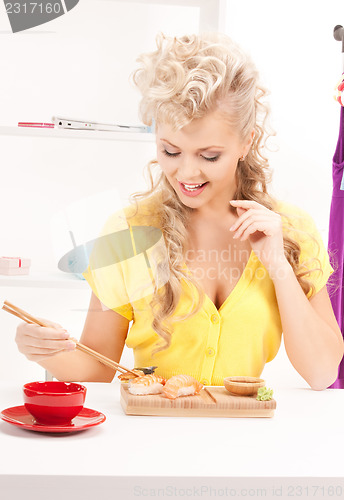 Image of lovely woman eating sushi