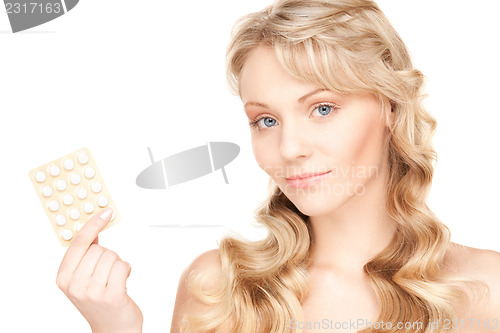 Image of young woman with pills