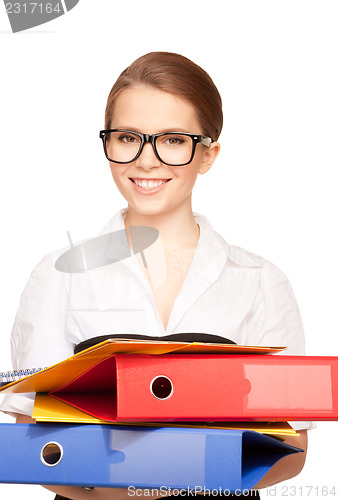 Image of young attractive businesswoman with folders