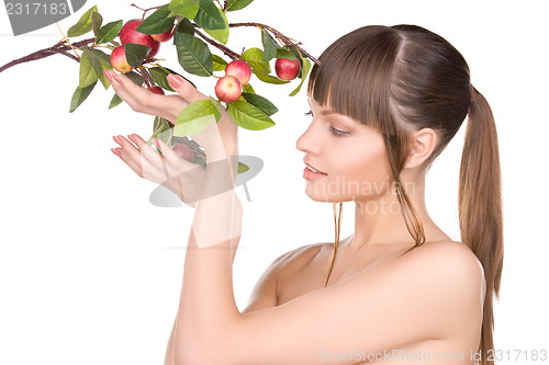 Image of lovely woman with apple twig