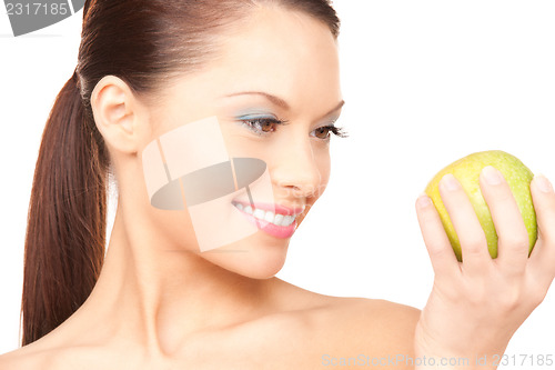 Image of young beautiful woman with green apple