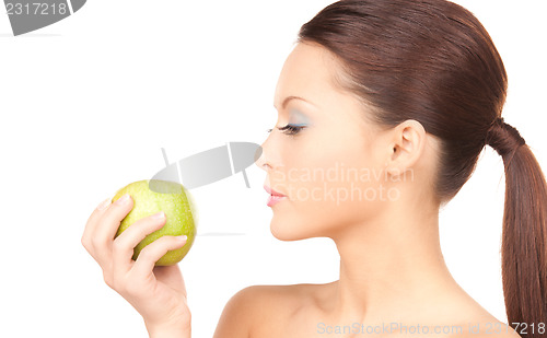 Image of young beautiful woman with green apple