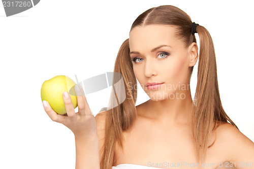Image of young beautiful woman with green apple