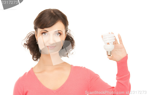 Image of woman holding energy saving bulb